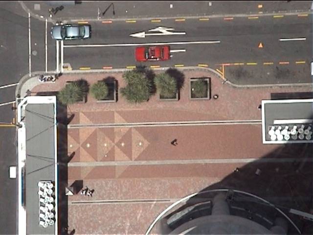 View of the ground below, through the glass floor of the skytower