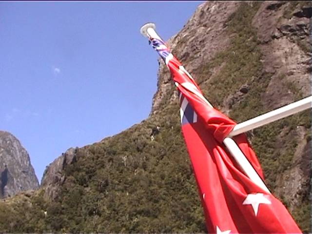 The NZ flag (maritime version) from the back of the Red Boat on Milford Sound